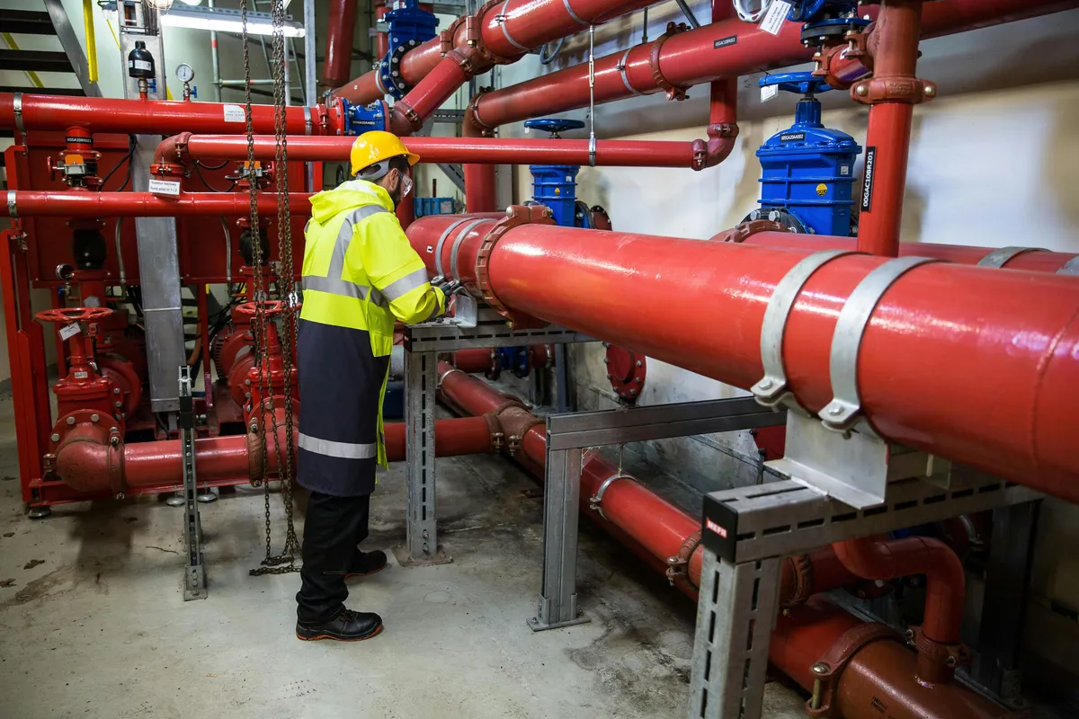man inspecting pipes